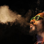 DENVER, CO - APRIL 19: Snoop Lion exhales a heart shaped cloud of marijuana smoke while doing a Q&A with the audience after the screening of his documentary Reincarnated during the first ever "Green Carpet" event as a part of the High Times US Cannabis Cup at the Fillmore Auditorium on April 19, 2013 in Denver, Colorado. (Photo by Seth McConnell/The Denver Post via Getty Images)