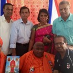 Swamiji, second left, foreground is seen with Toronto’s John Persaud, fourth left, background. The historian and theologian fashioned his lifestyle after India’s Swami Purnananda who visited Guyana.