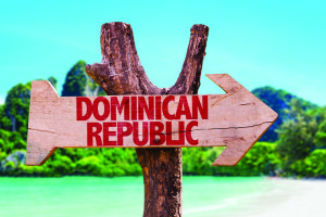 Dominican Republic wooden sign with beach background