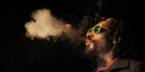 DENVER, CO - APRIL 19: Snoop Lion exhales a heart shaped cloud of marijuana smoke while doing a Q&A with the audience after the screening of his documentary Reincarnated during the first ever "Green Carpet" event as a part of the High Times US Cannabis Cup at the Fillmore Auditorium on April 19, 2013 in Denver, Colorado. (Photo by Seth McConnell/The Denver Post via Getty Images)