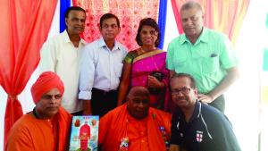 Swamiji, second left, foreground is seen with Toronto’s John Persaud, fourth left, background. The historian and theologian fashioned his lifestyle after India’s Swami Purnananda who visited Guyana.