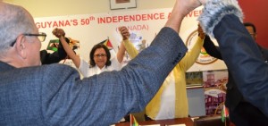 Honourary Consul General Sattie Sawh joins hands at the Guyana Consulate with members of the 50th Independence Anniversary (Canada) Committee. Gerald V. Paul photo.