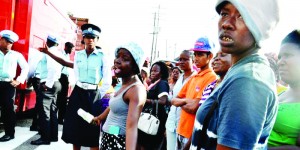 Relatives await news outside Guyana’s notorious Camp Street Prison in which rioting claimed 17 lives.