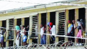 Rioting inmates of the the Camp Street Prison, look out the prison windows in Georgetown, Guyana,