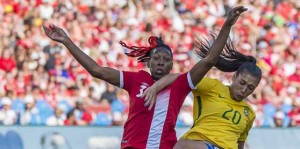 An ever-hopeful crowd shows the flag last weekend. Canada’s national women’s team met Brazil in a friendly match, which the visitors won 2-0 at BMO Field despite heroic efforts by Canada’s Kadeisha Buchanan No. 3 and Sophie Schmitdt No. 13, here battling Brazil’s high scoring star Marta No. 10, who netted both goals. The Canadians redeemed themselves Monday night in Ottawa, beating Brazil 1-0 in a rematch. Gerard Richardson photos.
