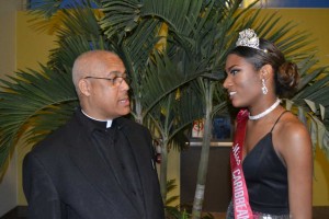 Rev. Fr. C. Guiseppi, pastor and director of Our Lady of Good Counsel Caribbean-Canadian Roman Catholic Church chats with Desley Andrew-Augustin, Miss Caribbean Canada 2015, who received a scholarship in 2013. Gerald V. Paul photo.