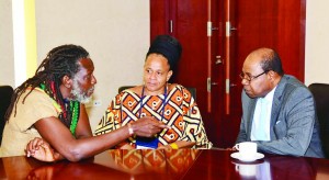 Minister of Tourism Edmund Bartlett (right) meets with Edi Wray, of the Rastafari indigenous village after addressing Canex Jamaica, the island’s first Cannabiscentred conference on the business potential of the marijuana trade. listening attentively is Mitzie Williams